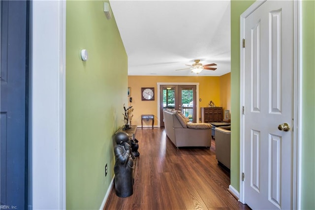 hall featuring dark wood finished floors, french doors, and baseboards