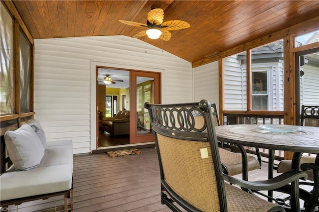 sunroom featuring ceiling fan, lofted ceiling, outdoor dining area, and healthy amount of natural light