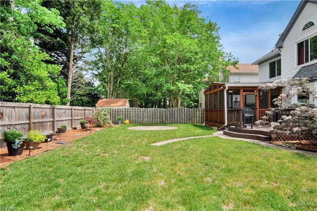 view of yard with a sunroom and a wooden deck
