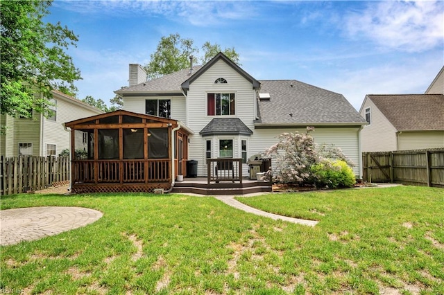 back of property with a sunroom, a shingled roof, a wooden deck, and a chimney