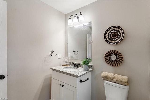 bathroom featuring toilet and vanity
