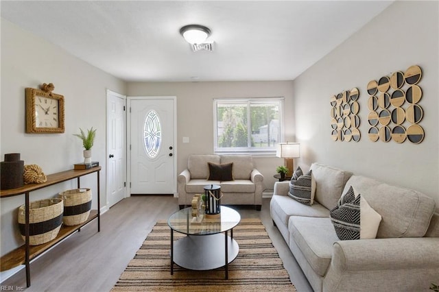 living area featuring wood finished floors and visible vents