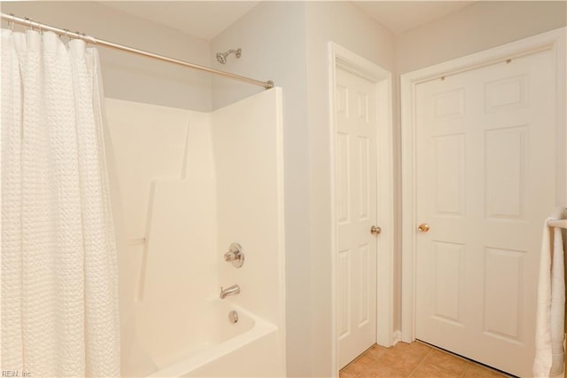 full bath with tile patterned flooring and shower / bath combo