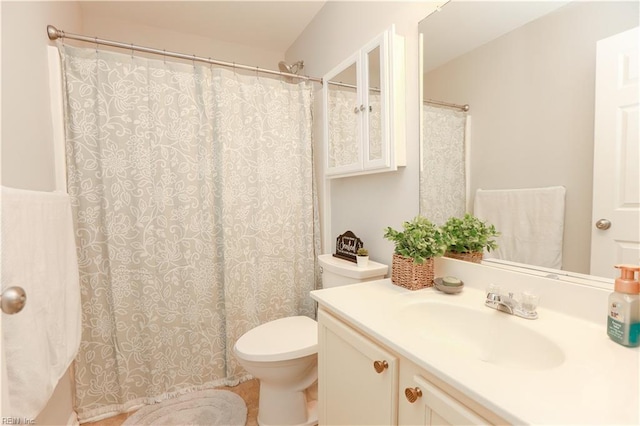 bathroom featuring vanity, curtained shower, and toilet