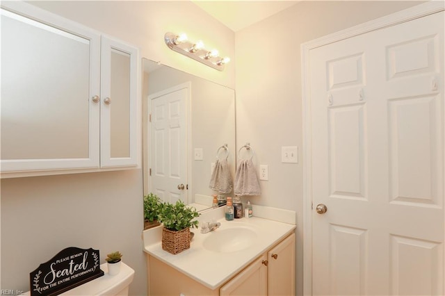 half bath with vanity and toilet