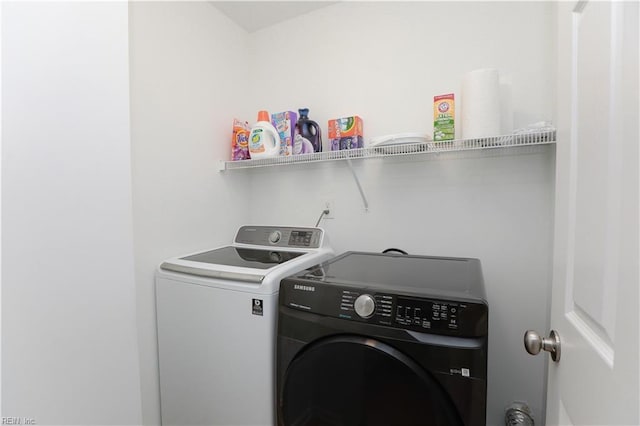 washroom with independent washer and dryer and laundry area
