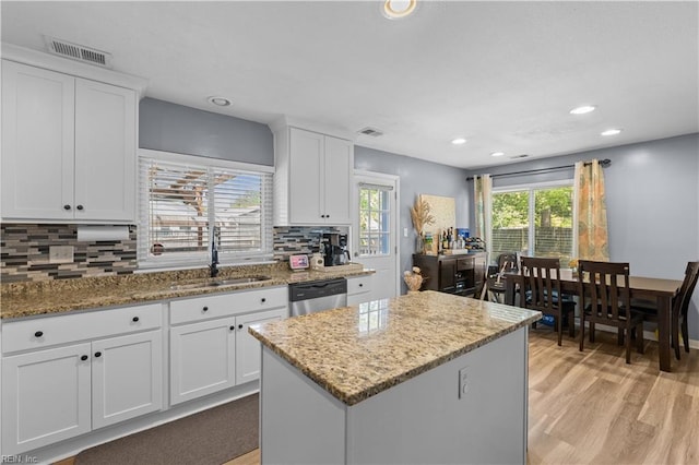 kitchen featuring a sink, dishwasher, recessed lighting, decorative backsplash, and visible vents