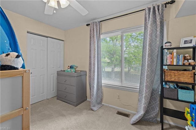 bedroom featuring ceiling fan, carpet, baseboards, visible vents, and a closet