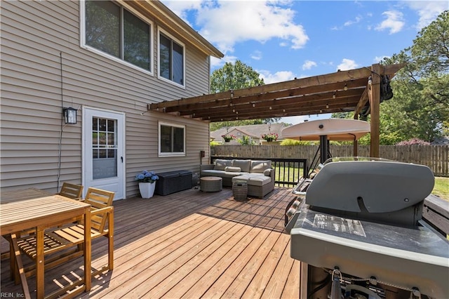 deck featuring area for grilling, an outdoor hangout area, and a fenced backyard