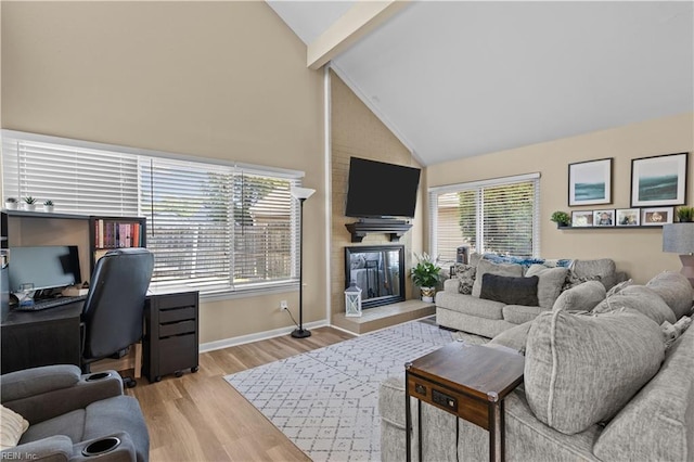 living area featuring a fireplace, beamed ceiling, baseboards, high vaulted ceiling, and light wood finished floors
