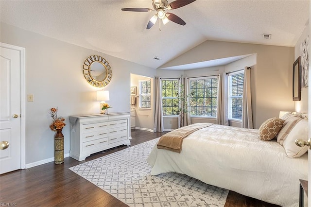 bedroom featuring visible vents, wood finished floors, lofted ceiling, baseboards, and a textured ceiling