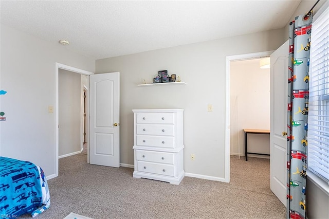 carpeted bedroom featuring baseboards