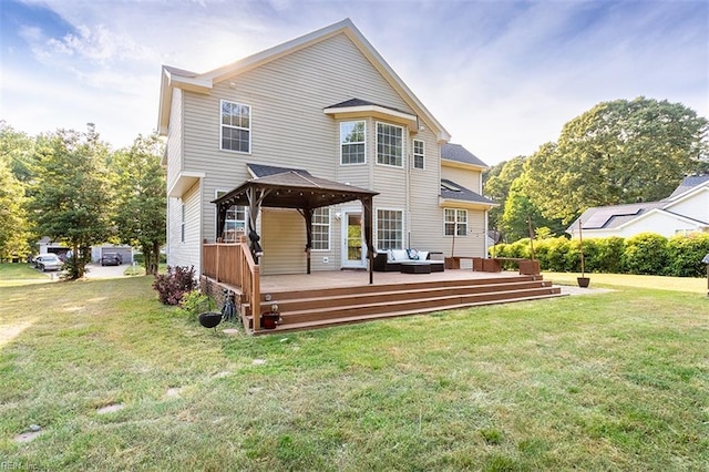 back of house with a gazebo, a lawn, an outdoor hangout area, and a deck