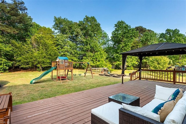 wooden terrace with a playground, a gazebo, a yard, and outdoor lounge area