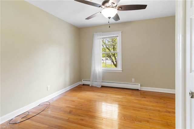 empty room with baseboards, a ceiling fan, light wood finished floors, and a baseboard heating unit
