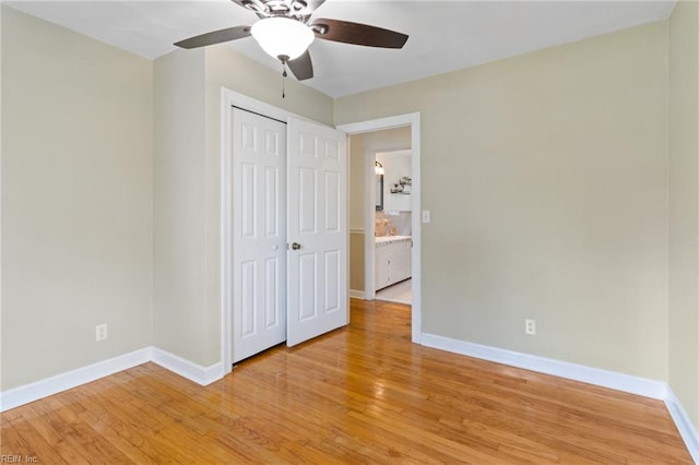 unfurnished bedroom with baseboards, light wood-style flooring, ceiling fan, and a closet