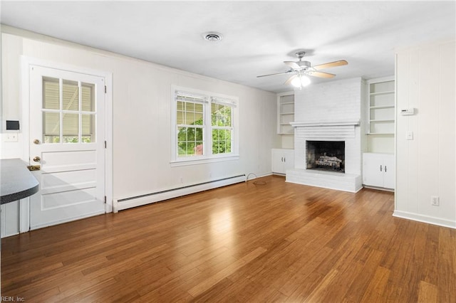 unfurnished living room featuring a fireplace, a ceiling fan, wood finished floors, a baseboard radiator, and visible vents