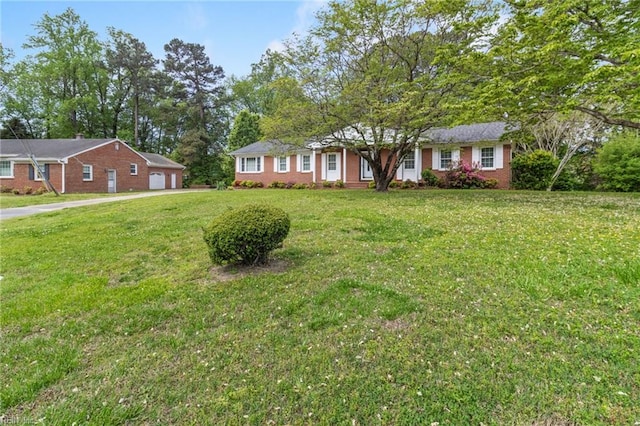 ranch-style house with brick siding and a front yard