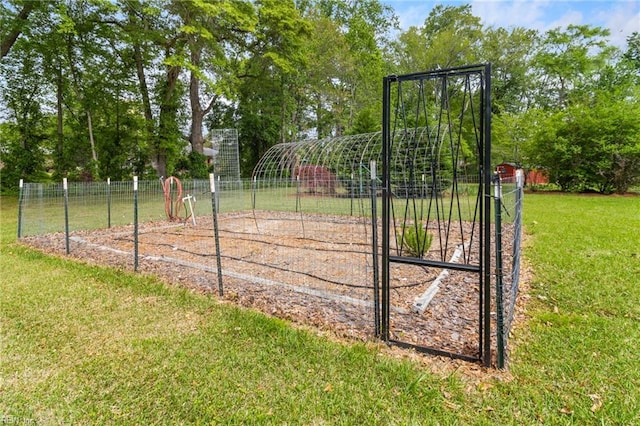 view of home's community with fence and a yard