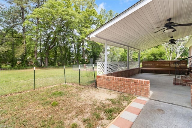 view of yard featuring ceiling fan, fence, and a patio area