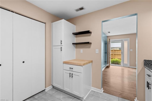 mudroom with baseboards and light tile patterned floors