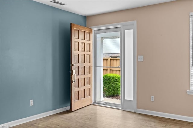 entryway with wood finished floors and baseboards