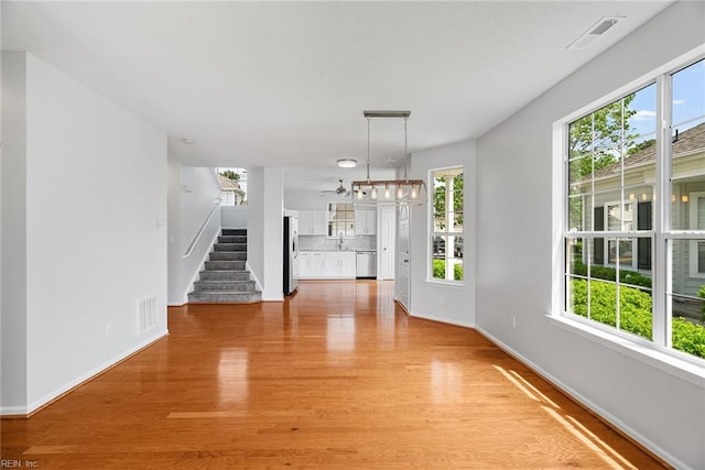 2513 Covent Garden Rd, Virginia Beach, VA 23456 - unfurnished dining area featuring light wood-type flooring, stairs, and a wealth of natural light