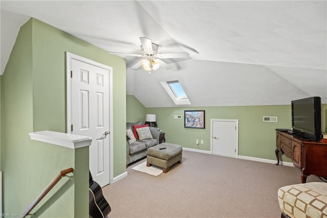living area with ceiling fan, visible vents, baseboards, lofted ceiling with skylight, and carpet