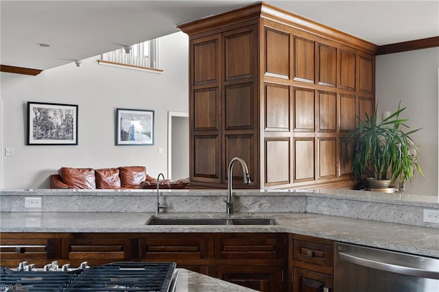 kitchen featuring light stone counters, a sink, and appliances with stainless steel finishes