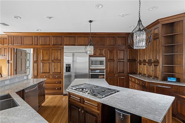 kitchen with open shelves, built in appliances, wood finished floors, recessed lighting, and a center island
