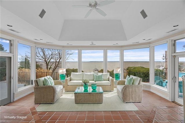 sunroom / solarium with tile patterned floors, a tray ceiling, and visible vents