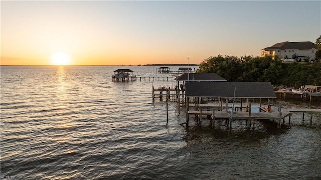 view of dock with boat lift and a water view
