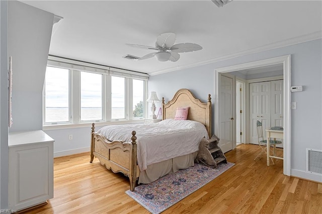 bedroom with baseboards, light wood-type flooring, and visible vents