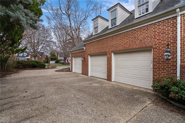 garage featuring aphalt driveway