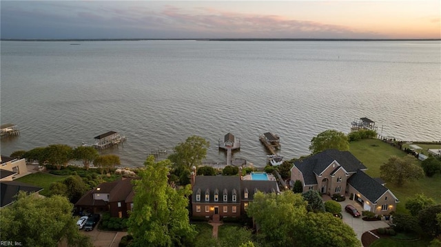 aerial view at dusk with a water view