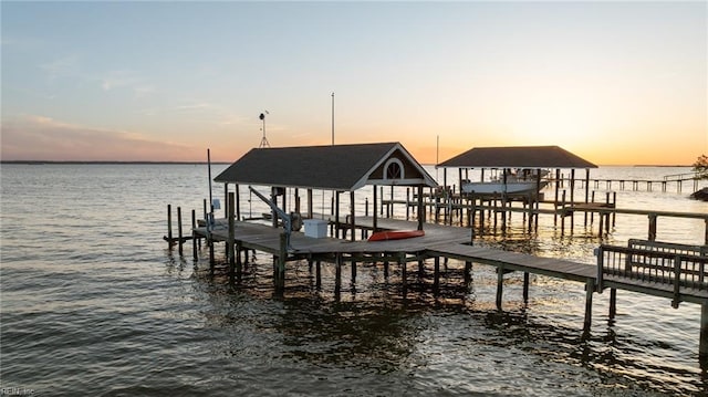 dock area featuring boat lift and a water view