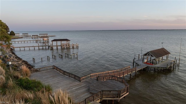 dock area with a water view and boat lift