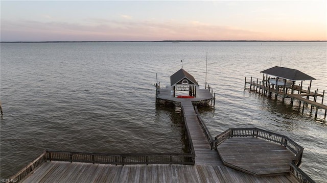 dock area with a water view and boat lift