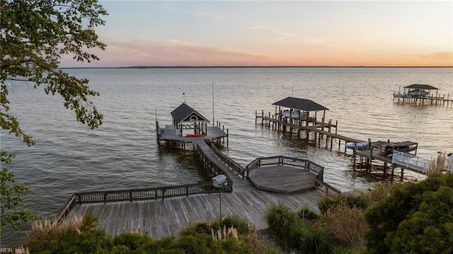 dock area with boat lift and a water view