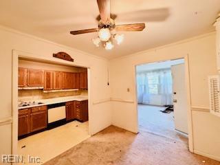 3009 Mattox Dr, Chesapeake, VA 23325 - kitchen featuring crown molding, light countertops, ceiling fan, and brown cabinets