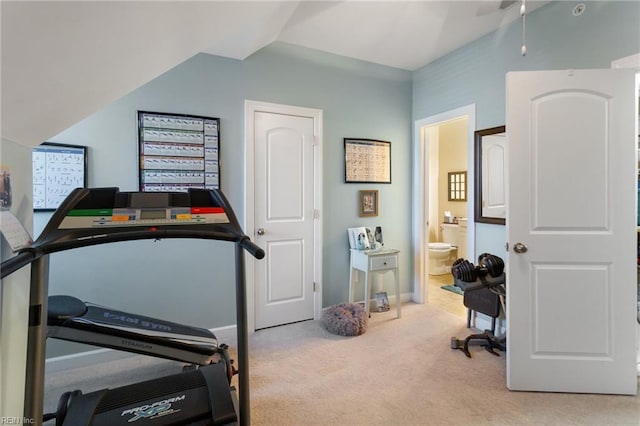 interior space with baseboards, ceiling fan, and vaulted ceiling