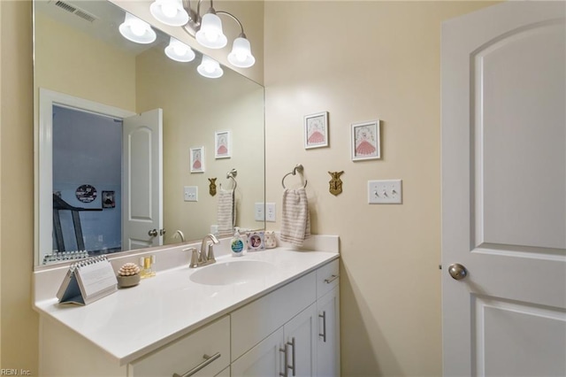 bathroom featuring vanity, a chandelier, and visible vents