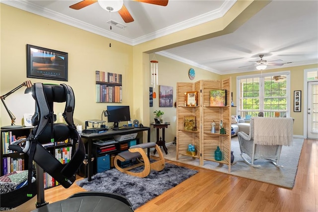 office featuring visible vents, ornamental molding, wood finished floors, baseboards, and ceiling fan