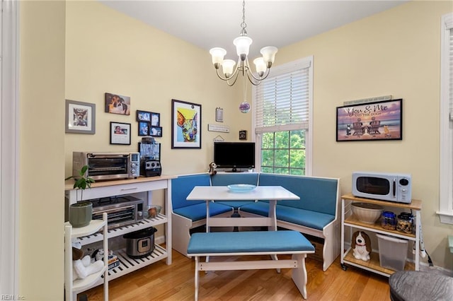office space featuring an inviting chandelier and wood finished floors