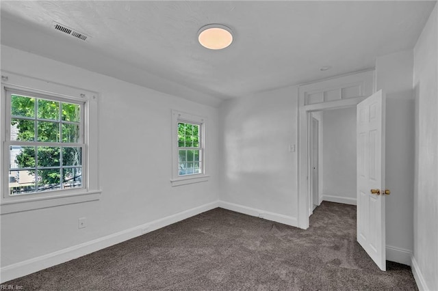 37 Farragut St, Portsmouth, VA 23702 - spare room with baseboards, dark colored carpet, and visible vents