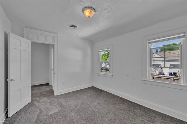 37 Farragut St, Portsmouth, VA 23702 - unfurnished bedroom featuring baseboards, dark carpet, a textured ceiling, and visible vents