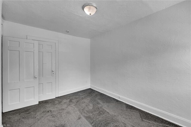 37 Farragut St, Portsmouth, VA 23702 - unfurnished room featuring a textured ceiling, baseboards, a textured wall, and dark carpet