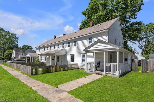37 Farragut St, Portsmouth, VA 23702 - back of property with covered porch, a lawn, a fenced front yard, and a chimney