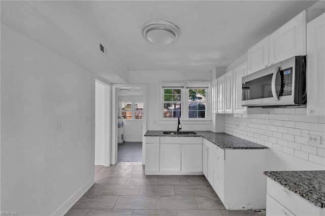37 Farragut St, Portsmouth, VA 23702 - kitchen with visible vents, a sink, white cabinets, stainless steel microwave, and dark stone countertops