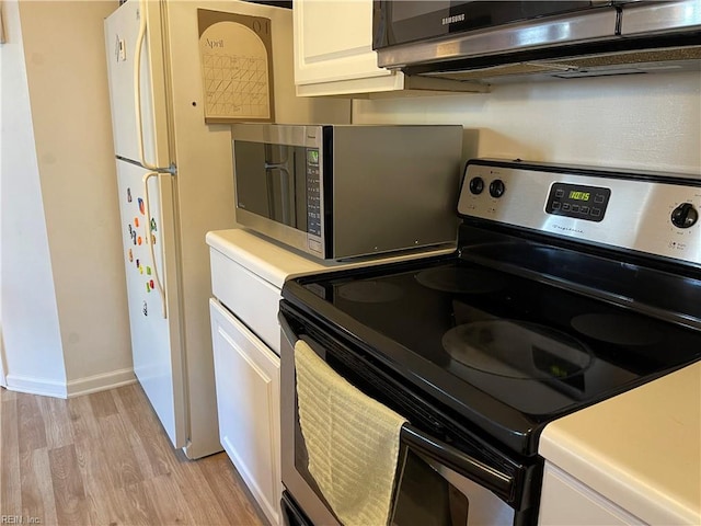 kitchen featuring light countertops, light wood finished floors, white cabinetry, and stainless steel appliances